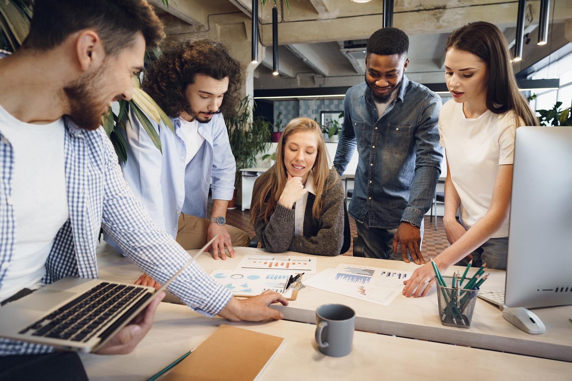 team diverse coworkers modern office discuss their project together