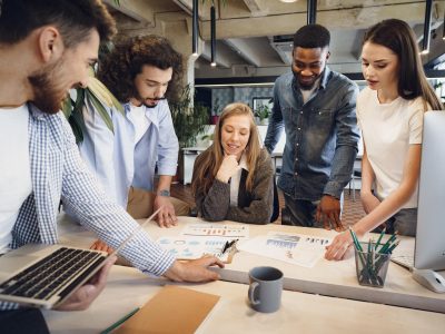team diverse coworkers modern office discuss their project together